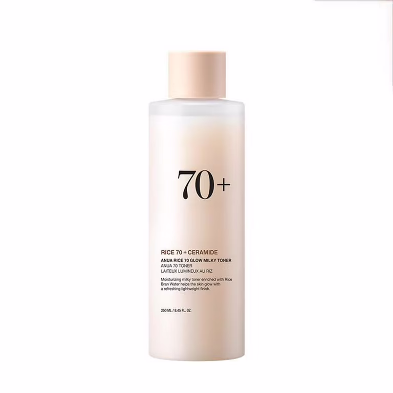 A 250ml white bottle of ANUA Rice 70+ Glow Milky Toner on a white background. Label emphasizes "70% Rice Bran Water" and "Ceramide Complex." Ideal for humid climates, it hydrates and brightens oily, dry, or sensitive skin without irritation.
