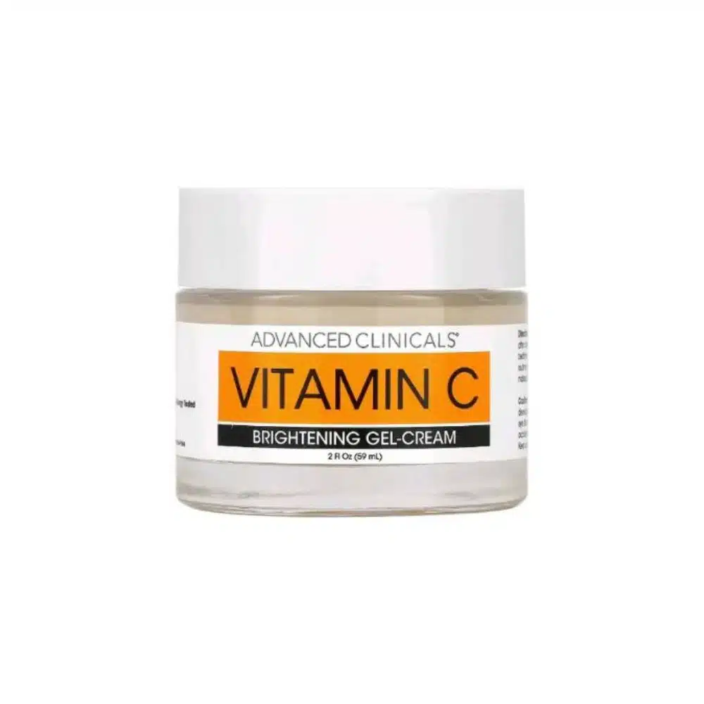 Advanced Clinicals Vitamin C Brightening Face Gel-Cream in minimalist orange-and-white packaging on a white background. The jar is open, showing a smooth gel-cream texture. A hand applies the product to glowing cheekbones, emphasizing its lightweight, fast-absorbing formula ideal for humid climates.