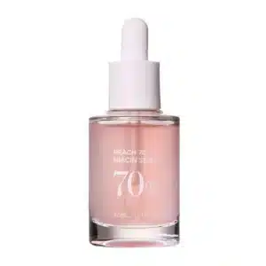 ANUA Peach 70 Niacin Serum in a sleek 30ml dropper bottle on white background. Features natural peach extract, niacinamide, and hyaluronic acid for brightening and hydration. Pink serum visible through glass, ideal for dull, dry, or uneven skin tones in tropical climates.