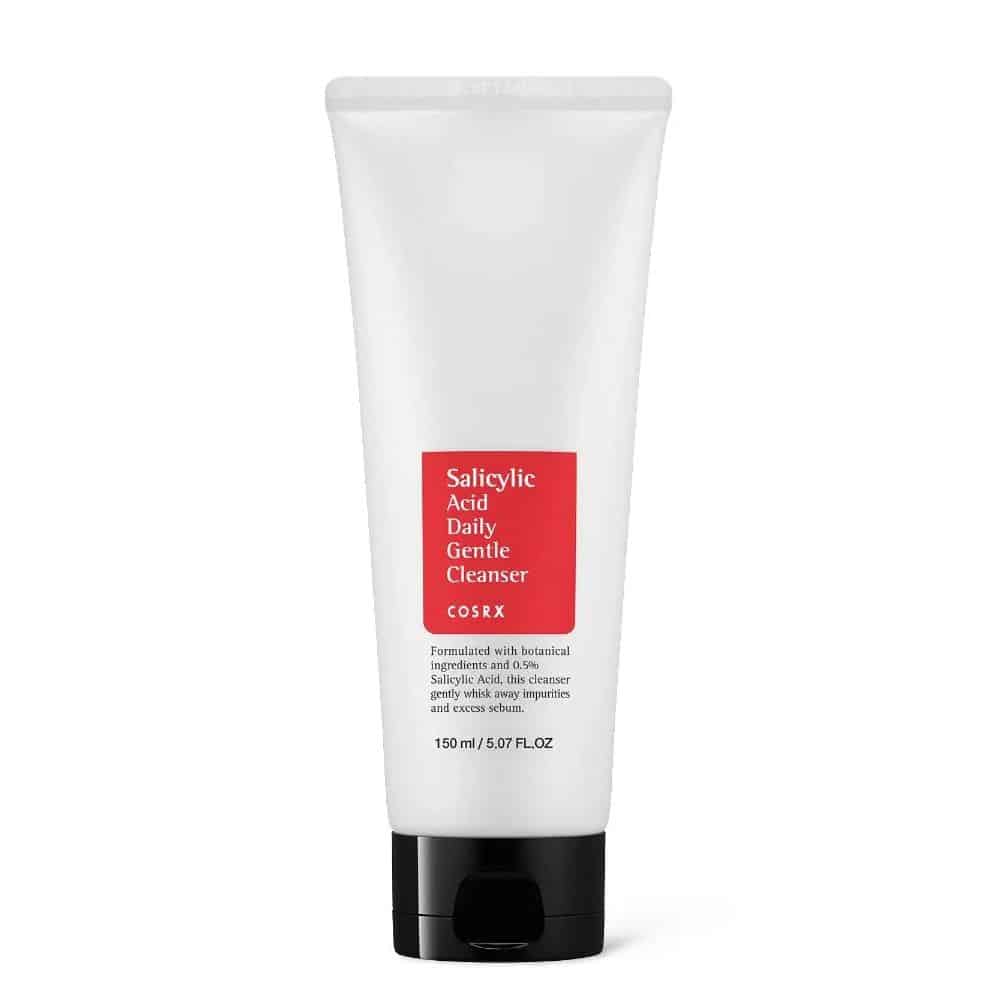 COSRX Salicylic Acid Daily Gentle Cleanser (150ml pump bottle) on white background. Label highlights "0.5% BHA," "Tea Tree Oil," and "Gentle Exfoliation." Ideal for oily, acne-prone skin in tropical climates like Ghana.